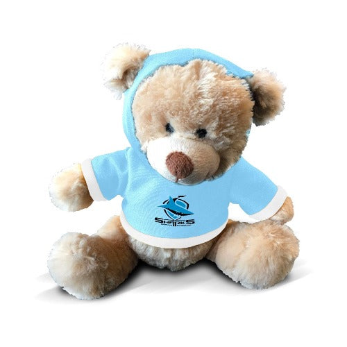 A plush teddy bear with a hoodie, featuring a team logo, in a light blue and beige color scheme.
