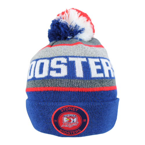 A blue, red, and white sydney roosters beanie with an embroidered team patch and a multicolored pom-pom on top.