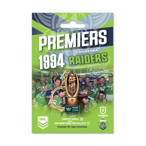A 3D trophy keyring featuring the Canberra Raiders 1994 Premiers design, with a green and yellow color scheme and an image of a trophy in the center.