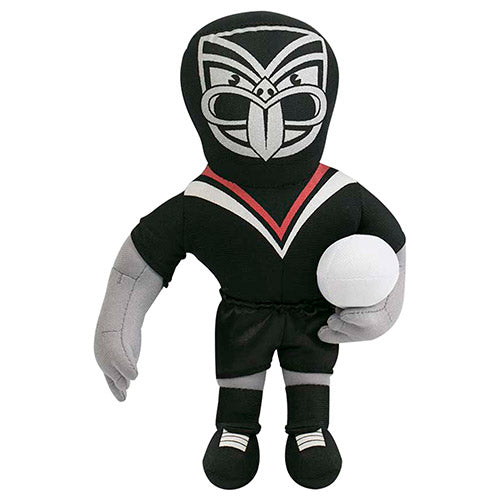 A plush toy in the likeness of a New Zealand Warriors sports mascot, dressed in black and gray attire with a face design, holding a rugby ball.