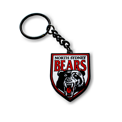 A metal keyring with a North Sydney Bears logo featuring a bear's face, predominantly red and white in color.